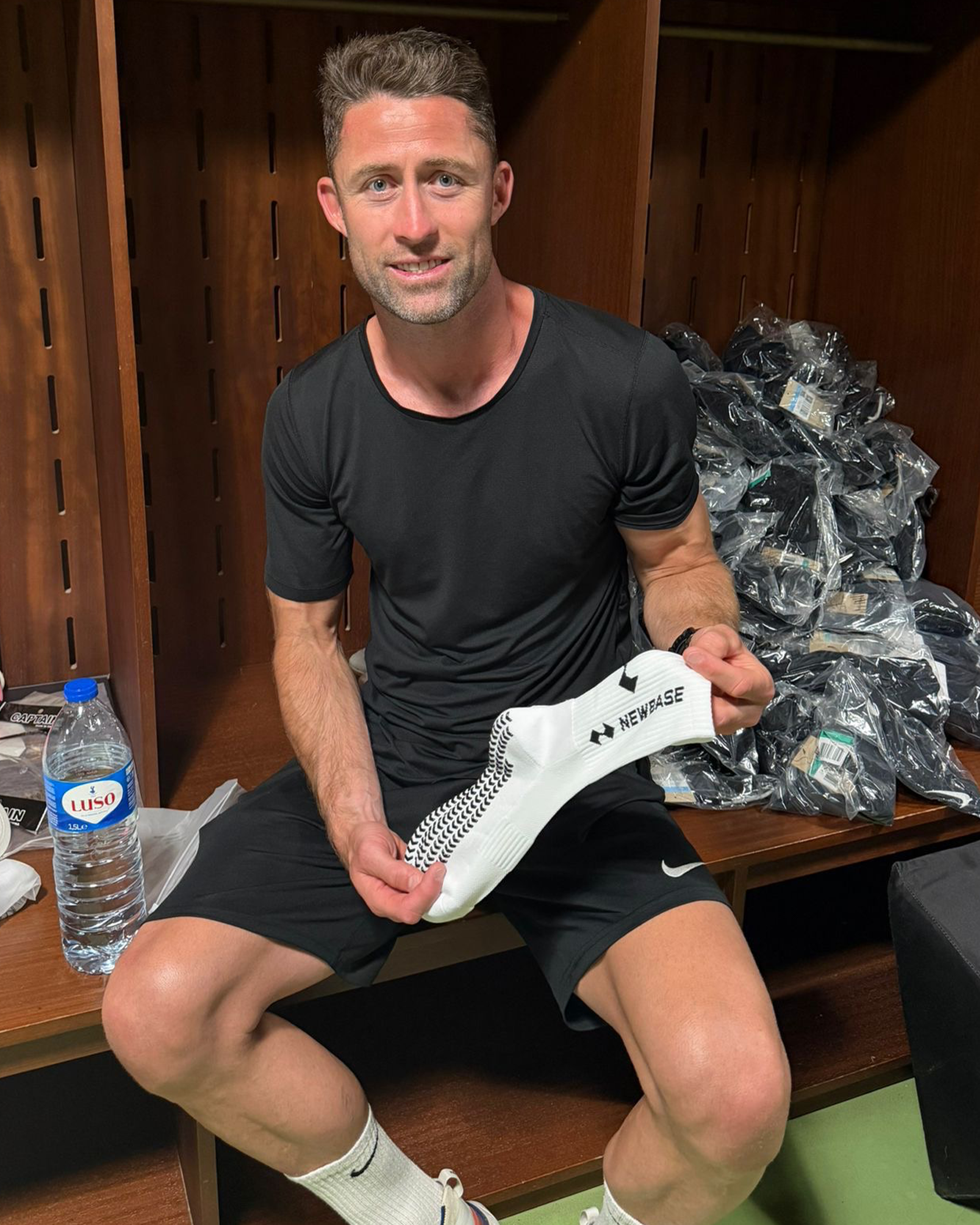 Gary Cahill holding NewBase grip socks